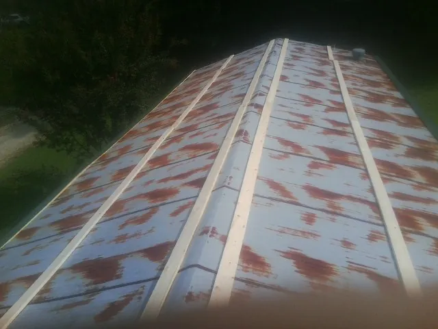 Rusted metal roof panels with new wood purlins before replacement — Storm Damage Roof Repair in Sauk Rapids by Roofing Brothers